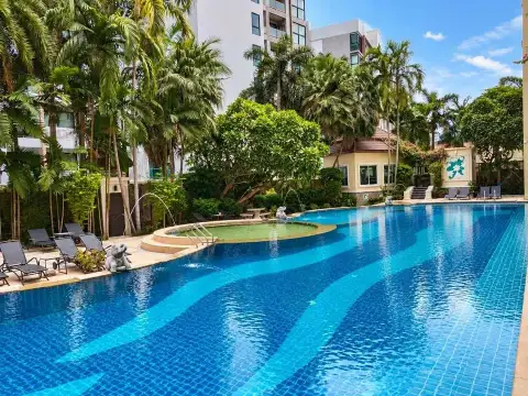 1 Bedroom Condo for Sale at The Residence Jomtien lagoon-style swimming pool surrounded by tropical palm trees