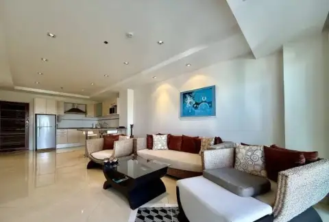 2 Bedroom Condo for Sale at The Residence Jomtien living area with blue artwork and woven furniture
