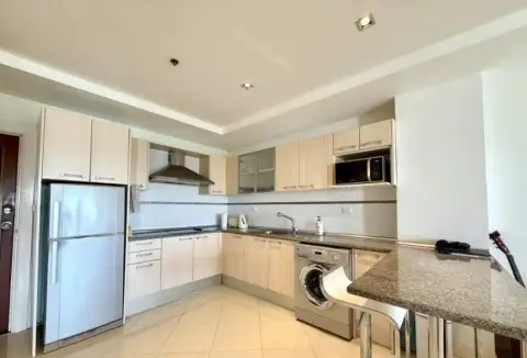 2 Bedroom Condo for Sale at The Residence Jomtien fitted kitchen with refrigerator and washing machine