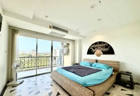 2 Bedroom Condo for Sale at The Residence Jomtien master bedroom with rattan bed and balcony city view
