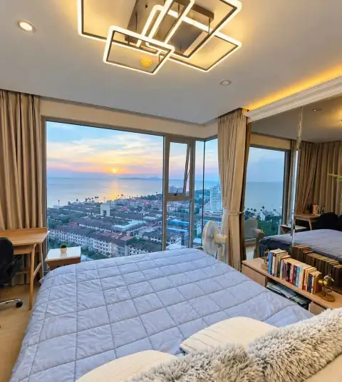 2 Bedroom Condo for Rent at The Riviera Jomtien master bedroom with floor-to-ceiling windows and sea sunset view