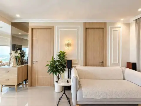 2 Bedroom Condo for Rent at The Riviera Jomtien living room with beige sofa and elegant wood paneled walls