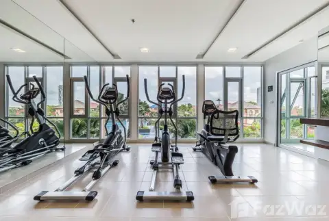 The Trust Condo South Pattaya fitness center with elliptical machines and large windows overlooking the pool