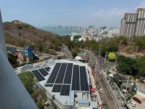 1 Bedroom Condo for Sale at The Vision elevated view of Pattaya cityscape, coastline and solar panel rooftop