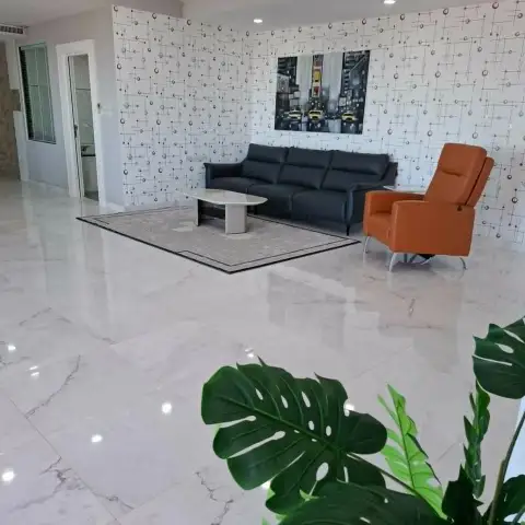 3 Bedroom Condo for Sale at Tropicana Pratumnak spacious living area with marble flooring and patterned accent wall