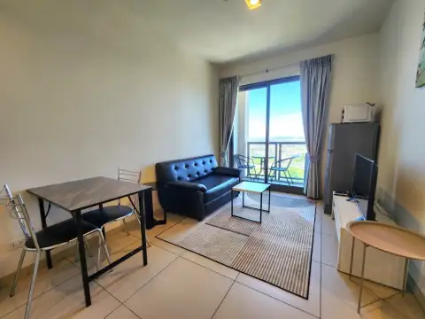 1 Bedroom Condo for Sale & Rent at Unixx South Pattaya living and dining area with sofa and balcony access