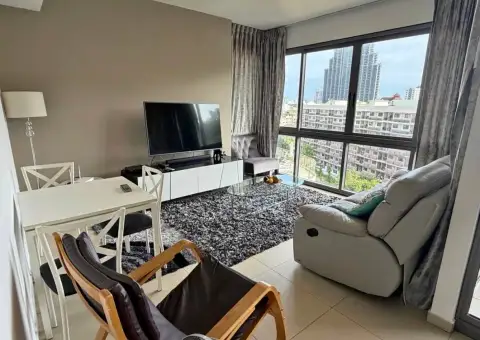 2 Bedroom Condo for Rent at Unixx South Pattaya open living and dining area with TV unit and high-rise view