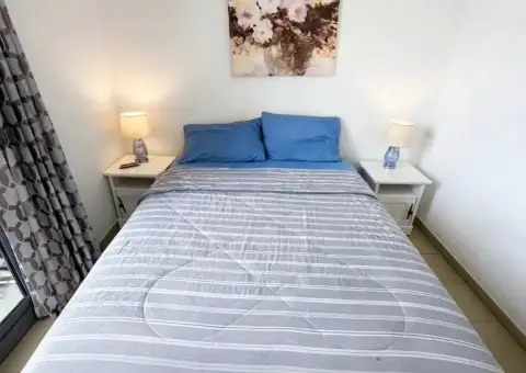 2 Bedroom Condo for Rent at Unixx South Pattaya second bedroom with blue bedding and floral wall art