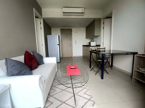 2 Bedroom Condo for Rent at Unixx South Pattaya open-plan living area with kitchenette, fridge and dining set
