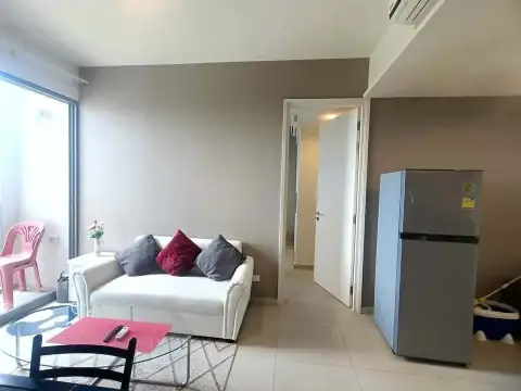 2 Bedroom Condo for Rent at Unixx South Pattaya hallway view with sofa, fridge and glass coffee table
