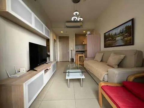 1 Bedroom Condo for Sale at Unixx South Pattaya living room with sofa, TV unit, and dining nook