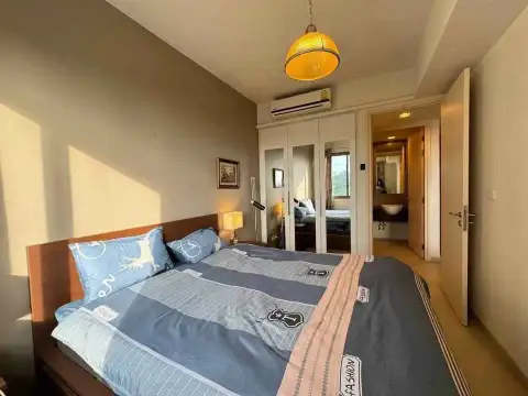 1 Bedroom Condo for Sale at Unixx South Pattaya bedroom with double bed, mirrored wardrobe, and ensuite