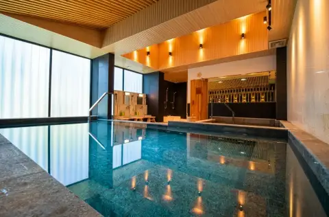 Dormy Residences Sriracha indoor reflective pool with wooden ceiling and ambient lighting
