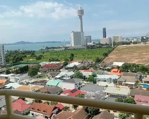 Studio Condo for Rent at View Talay 5D balcony view of Pattaya city rooftops, tower, and ocean coastline