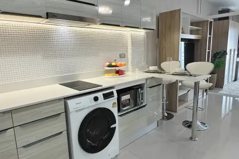 1 Bedroom Condo for Sale at View Talay 8 kitchenette with bar seating and view into bedroom and living space