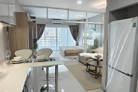 1 Bedroom Condo for Sale at View Talay 8 living room with wardrobe, TV unit, and glimpse of kitchen
