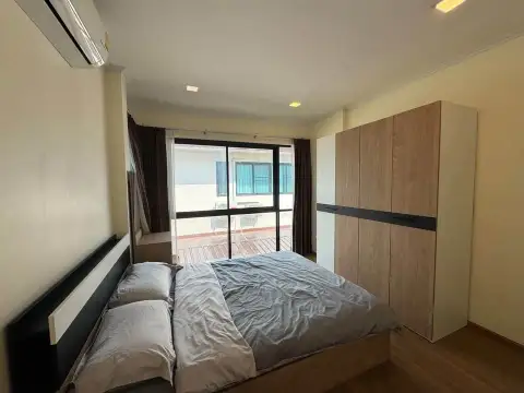 4 Bedroom House for Sale at Villa Asiatic bedroom with balcony access, wooden flooring, and built-in wardrobe