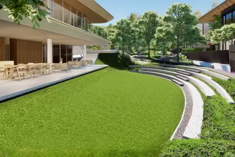 Solava Pattaya landscaped garden with curved stone amphitheatre steps lush green lawn and outdoor dining terrace
