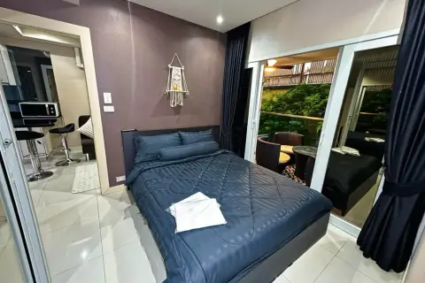 1 Bedroom Condo for Rent at VN Residence 3 bedroom with navy bedding and balcony view with greenery