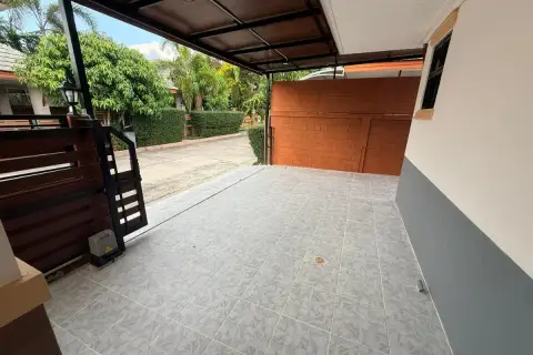 3 Bedroom House for Sale at Baan Dusit Pattaya Park covered driveway with tiled floor and automatic gate.
