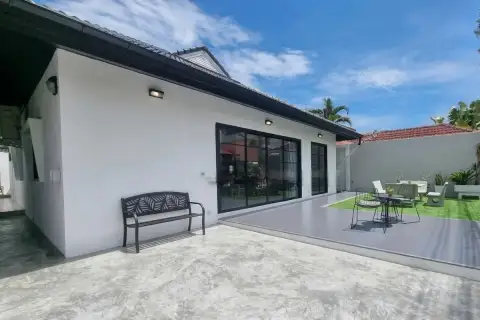 Royal Prestige outdoor patio with sliding glass doors, garden bench, dining set, and landscaped lawn