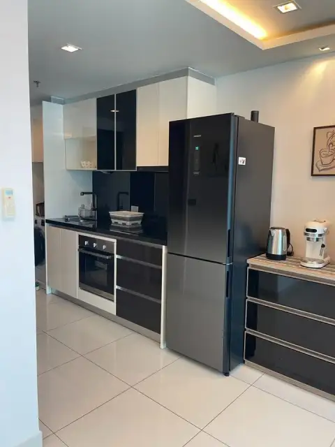 1 Bedroom Condo for Sale at Wongamat Tower modern kitchen with black fridge and built-in oven