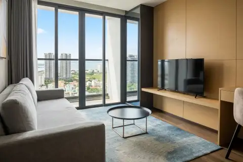 1 Bedroom Condo for Rent at Beverly Mountain Bay Pattaya living area with sofa and floor-to-ceiling city and sea view windows