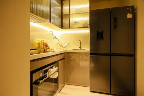 2 Bedroom Condo for Sale at Arom Jomtien compact kitchen with glass cabinets, stone countertop and Samsung fridge