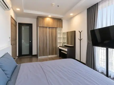 2 Bedroom Condo for Sale at Pattaya Posh bedroom with wooden wardrobe, vanity desk and wall-mounted TV