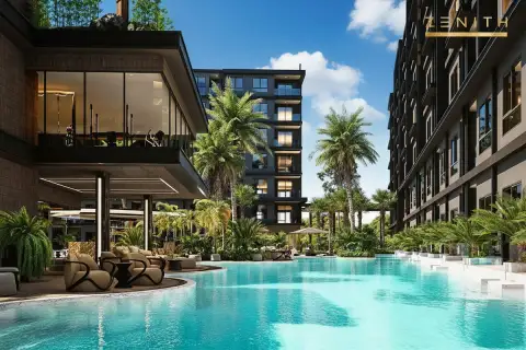 Zenith Pattaya large outdoor swimming pool with sun loungers, surrounded by modern buildings and palm trees.