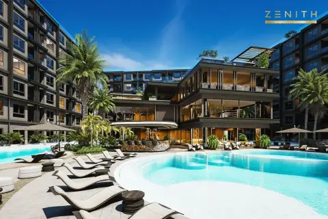 Zenith Pattaya outdoor swimming pool with white lounge chairs, surrounded by modern buildings and green landscaping.