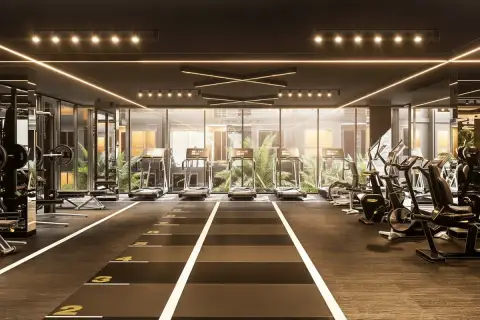 Zenith Pattaya state-of-the-art fitness center with treadmills, weight machines, and dark modern decor.