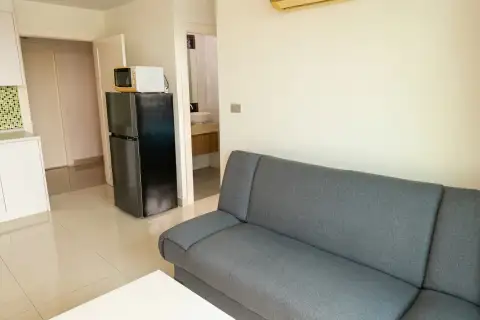1 Bedroom Condo for Sale at Amazon Residence hallway with black refrigerator, microwave, and bathroom entrance