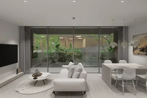 2 Bedroom Condo for Sale at Celine Wongamat modern living and dining area with panoramic glass doors overlooking lush garden