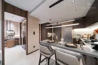 1 Bedroom Condo for Sale at Panora Estuaria: Kitchen dining bar with place settings, leading to a vanity area.