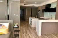 3 Bedroom Condo for Sale at Cetus Beachfront open-plan kitchen with marble breakfast bar and wood cabinetry