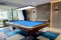 1 Bedroom Condo for Sale at Gardenia Pattaya close-up of blue felt billiard table with cue rack and slatted accent wall with warm lighting