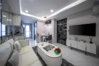 1 Bedroom Condo for Sale at Grand Solaire Noble living and dining area with cream sofa marble floor and gold-accent decor