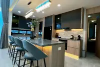5 Bedroom House for Sale at Impress House Village modern kitchen with marble island, bar stools, and crystal chandelier