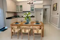 3 Bedroom House for Sale at SP Village 1 dining area with 6-seat wooden table, wishbone chairs and fitted kitchen with dark countertops