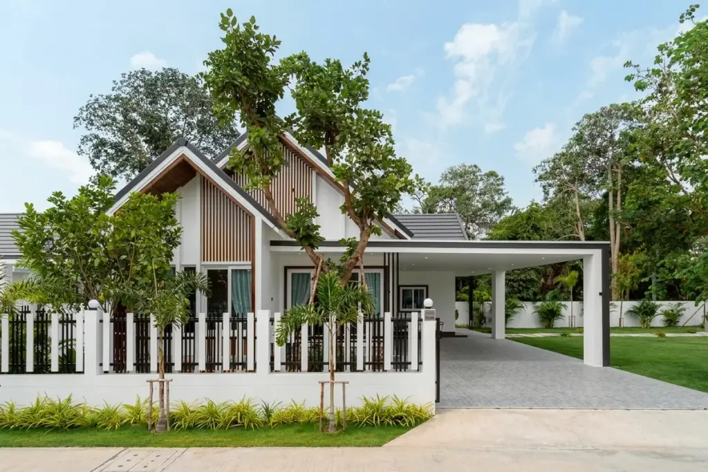 3 Bedroom House for Sale at Coco Ville 2 Pong - Bang Lamung modern exterior with wood-slat facade, carport, and lush tropical garden