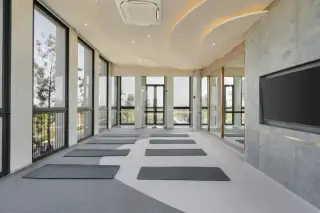 Cascade bright fitness center with large windows, cardio machines, and strength training equipment.