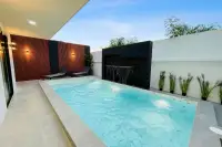 5 Bedroom House for Rent at View Point Village outdoor pool area with water feature wall and wooden panels