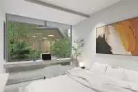 2 Bedroom Condo for Sale at Celine Wongamat modern bedroom with built-in desk, garden view glass window and abstract wall art