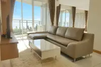 3 Bedroom Condo for Sale at Whale Marina bright living room with L-shaped leather sofa and floor-to-ceiling sea view windows
