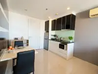 1 Bedroom Condo for Sale at The Vision compact kitchen with fridge, microwave, and dining table setup