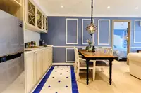 2 Bedroom Condo for Sale at Seven Seas Cote d'Azur: kitchen with light wood cabinets, stainless steel fridge, and dining area.