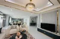 4 Bedroom House for Sale at Wonderland II open-plan living room with crystal chandelier gold accents and dining area