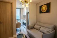 1 Bedroom Condo for Rent at Copacabana Beach Jomtien hallway view of living room and kitchenette with gold chandelier