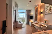 1 Bedroom Condo for Sale at The Twin Tower Jomtien Beach Pattaya open-plan living and dining area with floor-to-ceiling windows and city view